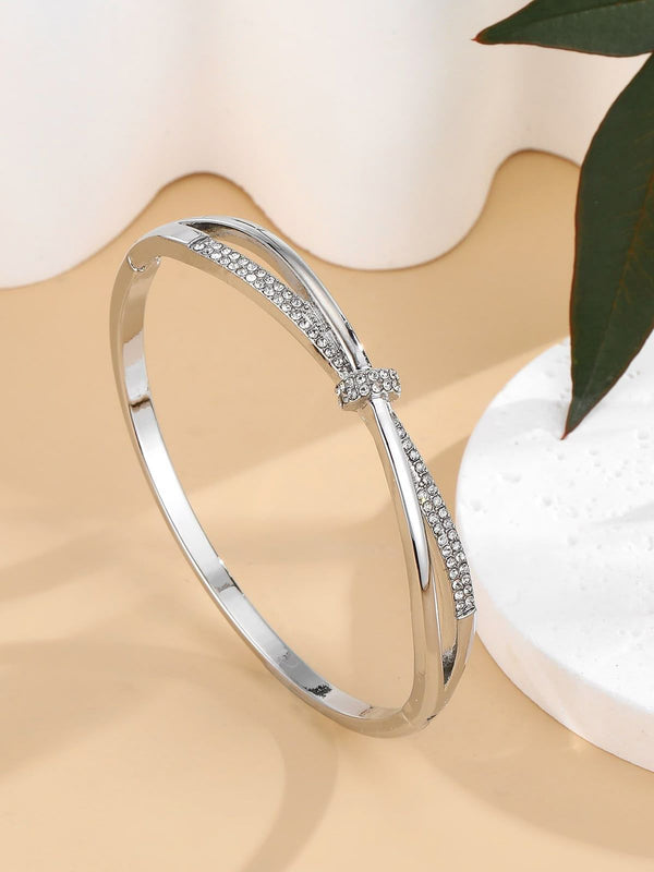a silver-toned knot cuff bangle bracelet with pavé rhinestones